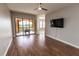 Bright, airy living room with hardwood floors, ceiling fan, and large sliding glass doors at 99 Vivante Blvd # 311, Punta Gorda, FL 33950
