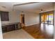 Spacious living room with hardwood floors, a wet bar, and sliding glass doors to the outdoor patio at 99 Vivante Blvd # 311, Punta Gorda, FL 33950