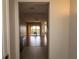 Hallway view leading into a living room with hardwood floors and sliding glass doors to the outside balcony at 99 Vivante Blvd # 311, Punta Gorda, FL 33950