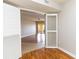 View of open living room with hardwood floors and access to a balcony at 99 Vivante Blvd # 311, Punta Gorda, FL 33950
