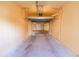 View of garage with door open, revealing concrete flooring and back door access at 99 Vivante Blvd # 311, Punta Gorda, FL 33950