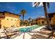 Relaxing poolside with plenty of lounge chairs, palm trees, and beautiful community landscaping at 99 Vivante Blvd # 311, Punta Gorda, FL 33950