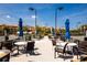 Inviting tennis court with adjacent seating areas, umbrellas, and lovely community landscaping at 99 Vivante Blvd # 311, Punta Gorda, FL 33950