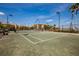 Full tennis court view, nestled among lush greenery and residential buildings under clear blue skies at 99 Vivante Blvd # 311, Punta Gorda, FL 33950