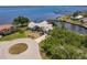 Aerial view of a waterfront house on a cul-de-sac with boat docks and open water access at 12439 Prather Ave, Port Charlotte, FL 33981