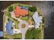 Aerial view showcases waterfront homes, lush green lawns, tile roofs and water access at 12439 Prather Ave, Port Charlotte, FL 33981