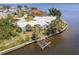 Aerial view of waterfront homes on a canal with boat dock at 12439 Prather Ave, Port Charlotte, FL 33981