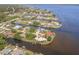 Waterfront community with canal access, lush landscaping, and unique home styles at 12439 Prather Ave, Port Charlotte, FL 33981