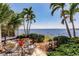 Relax on the back patio with seating, potted plants, and peaceful views of the serene waterfront at 12439 Prather Ave, Port Charlotte, FL 33981