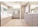 Bright bathroom featuring double vanity sinks, bathtub and shower with tile flooring and recessed lighting at 12439 Prather Ave, Port Charlotte, FL 33981