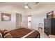 A comfy bedroom featuring a queen bed with dark wood frame, tile flooring, and modern furnishings at 12439 Prather Ave, Port Charlotte, FL 33981