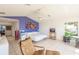 Bright bedroom boasts a colorful accent wall, tile flooring, and views of the water at 12439 Prather Ave, Port Charlotte, FL 33981