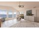 Bright bedroom with water views, tile flooring, a ceiling fan and vaulted ceilings at 12439 Prather Ave, Port Charlotte, FL 33981