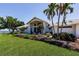 Inviting one-story home with lush landscaping and a well-manicured lawn at 12439 Prather Ave, Port Charlotte, FL 33981