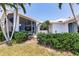 Home exterior shows a spacious screened patio and well-maintained landscaping at 12439 Prather Ave, Port Charlotte, FL 33981