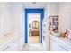 Hallway with white cabinets and a blue accent wall leading to another room at 12439 Prather Ave, Port Charlotte, FL 33981