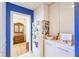 White hallway with a view of the living space and gold accented furniture at 12439 Prather Ave, Port Charlotte, FL 33981