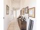 Hallway featuring tile floors, artwork and furniture at 12439 Prather Ave, Port Charlotte, FL 33981