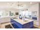 Spacious, well-lit kitchen featuring a modern island with sleek blue cabinets at 12439 Prather Ave, Port Charlotte, FL 33981