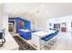 Kitchen and breakfast bar with seating adjoins a living room with blue accent wall at 12439 Prather Ave, Port Charlotte, FL 33981
