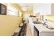 Well-lit laundry room offers functionality with counter space and storage options at 12439 Prather Ave, Port Charlotte, FL 33981