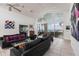 Spacious living room with waterfront views, high ceilings, and modern furnishings at 12439 Prather Ave, Port Charlotte, FL 33981