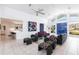 Bright, open living room with high ceilings, tile floors, and stylish contemporary furniture at 12439 Prather Ave, Port Charlotte, FL 33981