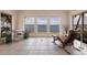 Water view living room features tile floors, white walls and beautiful water views from large picture windows at 12439 Prather Ave, Port Charlotte, FL 33981