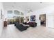 Open-concept living room with tile floors, high ceilings, and sliding glass doors leading to the patio at 12439 Prather Ave, Port Charlotte, FL 33981