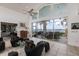 Bright living room with sliding glass doors leading to an outdoor patio and water views at 12439 Prather Ave, Port Charlotte, FL 33981