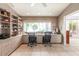 Home office with custom shelving, a large window overlooking the outside, and two work stations at 12439 Prather Ave, Port Charlotte, FL 33981