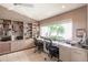 Bright home office space with custom shelving, large window with bright view, and two chairs at 12439 Prather Ave, Port Charlotte, FL 33981