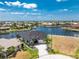 Stunning aerial view of waterfront home with lush landscaping, a private boat dock, and beautiful canal views at 1255 Eider Ct, Punta Gorda, FL 33950