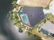 An aerial view of a home with a private dock, pool, and lanai surrounded by lush landscaping at 1255 Eider Ct, Punta Gorda, FL 33950