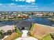 Beautiful home on a canal with a private dock and lift, surrounded by palm trees and stunning landscaping at 1255 Eider Ct, Punta Gorda, FL 33950