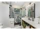 Modern bathroom with a tiled shower, marble countertop, and black fixtures at 1255 Eider Ct, Punta Gorda, FL 33950