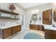 This bathroom boasts wooden cabinets, floating shelves and double sinks at 1255 Eider Ct, Punta Gorda, FL 33950