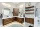 Light and bright bathroom with round mirrors, dual sinks, and floating shelves at 1255 Eider Ct, Punta Gorda, FL 33950