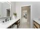 Bright bathroom featuring double vanity, modern fixtures, and an open doorway to the rest of the home at 1255 Eider Ct, Punta Gorda, FL 33950