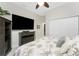 Bedroom featuring large TV, ceiling fan, closet, and palm-themed bedding at 1255 Eider Ct, Punta Gorda, FL 33950