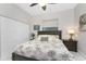 This bedroom features a ceiling fan, a palm-themed bed, and a double door closet at 1255 Eider Ct, Punta Gorda, FL 33950