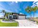 Beautiful single-story home with a manicured lawn, arched entryway and a two car garage at 1255 Eider Ct, Punta Gorda, FL 33950