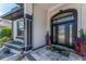 Stylish front entry showcasing a beautiful door with glass detailing and lush landscaping at 1255 Eider Ct, Punta Gorda, FL 33950