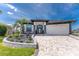 Beautiful single-story home with lush landscaping, paver driveway, and inviting curb appeal at 1255 Eider Ct, Punta Gorda, FL 33950