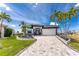 Beautiful home with well-manicured landscaping, brick driveway, and tropical palm trees at 1255 Eider Ct, Punta Gorda, FL 33950