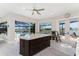 Bright open kitchen with a large island, stainless steel appliances, and seamless access to the outdoor pool at 1255 Eider Ct, Punta Gorda, FL 33950