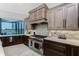 Gourmet kitchen boasts custom cabinets, marble countertops, and a stainless-steel Wolf range with waterfront views at 1255 Eider Ct, Punta Gorda, FL 33950