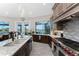 Bright kitchen featuring custom cabinets, granite countertops, stainless appliances, and a stunning water view at 1255 Eider Ct, Punta Gorda, FL 33950