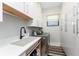 Functional laundry room with washer, dryer, and plenty of storage cabinets at 1255 Eider Ct, Punta Gorda, FL 33950