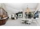 Open concept living room and dining area with elegant chandelier and modern furnishings at 1255 Eider Ct, Punta Gorda, FL 33950